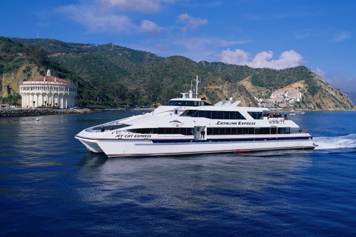 a small boat in a body of water with a mountain in the background